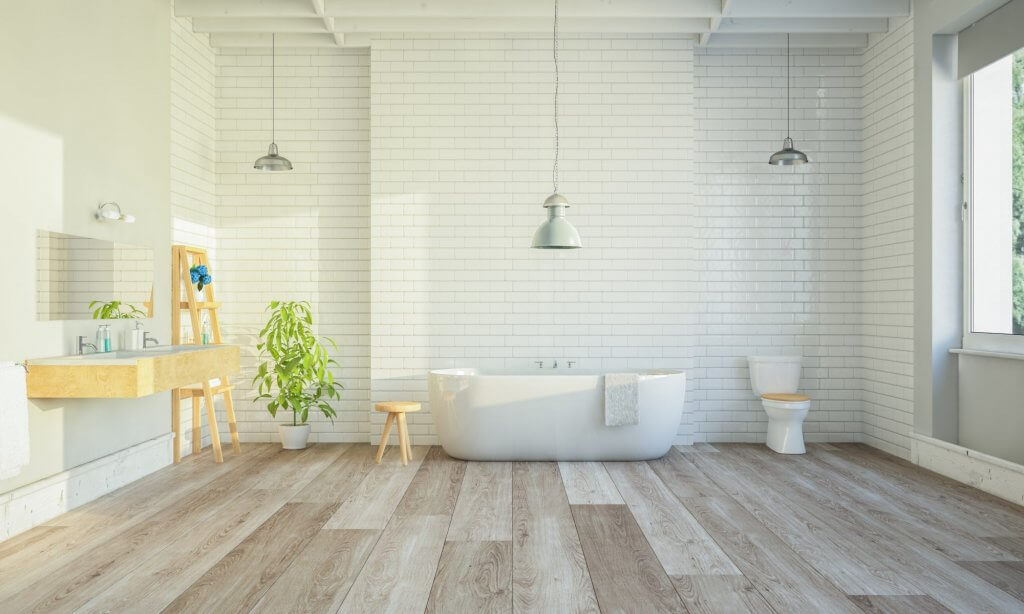 Stile cottagecore: nuova tendenza dell'interior design | Facile Ristrutturare Bagno con parquet chiaro con vasca bianca e parete in mattonelle con pianta laterale